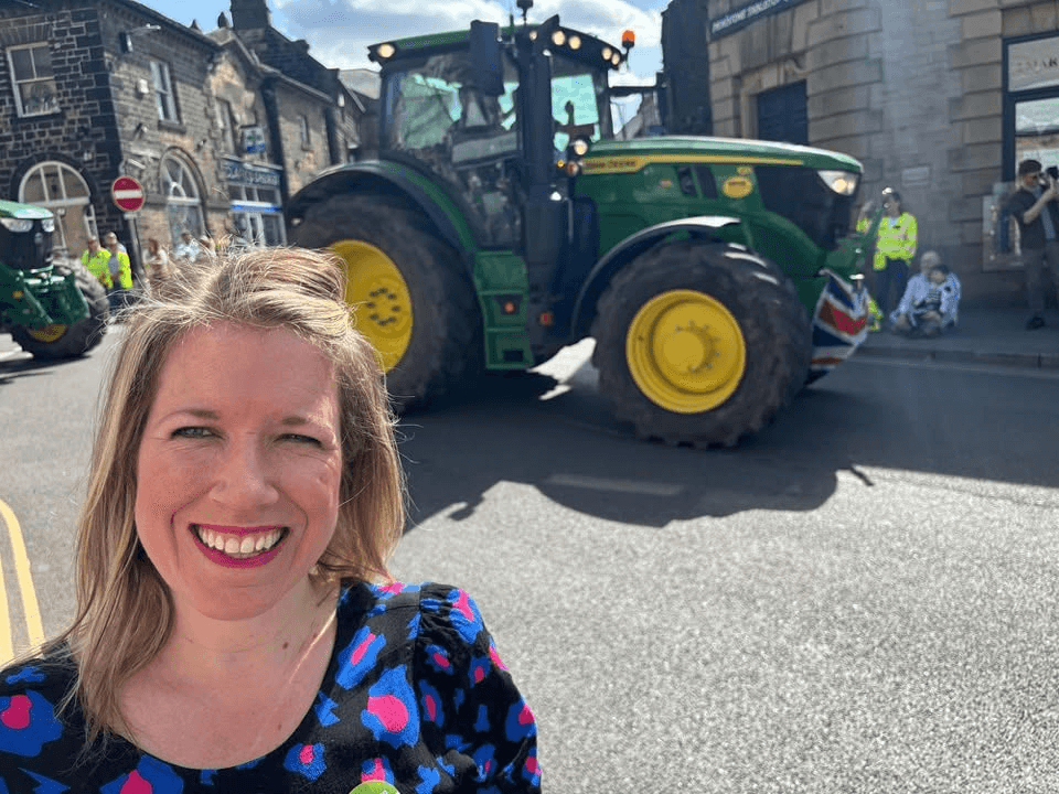 Marie Tibdall MP in front of a tractor at a local tractor run